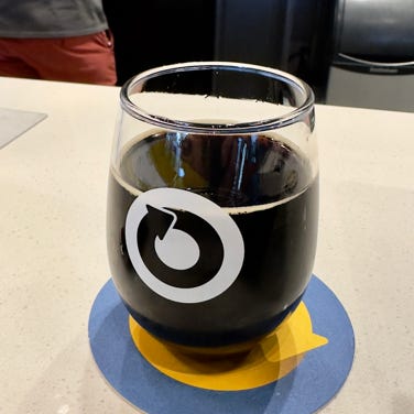 Creative artwork with Frida Kahlo painting decorated with colorful floral headband on graffiti wall